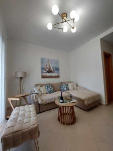 a living room with a couch and a table at Villa Danai Nefeli Siviri in Siviri +11 photos