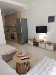 a living room with a table and a refrigerator at Villa Danai Nefeli Siviri in Siviri