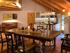 a kitchen with a large wooden table in a room at Gut Müllerleile Ferienhaus in Gengenbach +9 photos