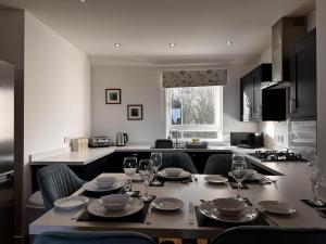 a table with glasses and plates on it in a kitchen at Loch Ore View in Kelty