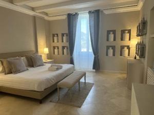 a bedroom with a large bed and a window at Relais Corte Degli Aragonesi in Ischia