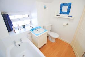 ein weißes Badezimmer mit Waschbecken und Toilette in der Unterkunft Hafan Cottage in Caernarfon + 25 Fotos
