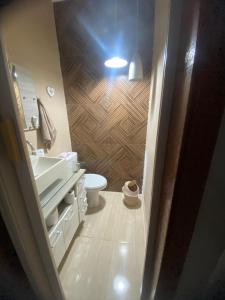 a bathroom with a sink and a toilet in it at Casa Marinho in São Pedro da Aldeia +1 photo