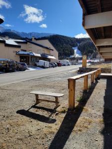a wooden bench sitting on the side of a street at Studio cabine face au Cambre d'aze in Saint-Pierre-dels-Forcats
