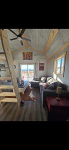 a living room with a couch and a loft at Quiet Country Cabin in Waiparous Village