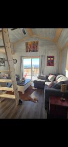 a living room with a bed and a couch at Quiet Country Cabin in Waiparous Village