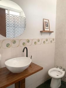 a bathroom with a sink and a toilet at Departamento Moreno in Rosario