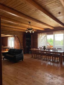 a large living room with a table and chairs at Rāznas Stāvkrasti in Kaunata