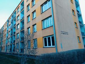 a tall building with a tree in front of it at Apartament Gagarina in Gliwice