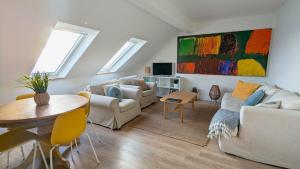 a living room with a couch and a table at Charming Beachfront Apartments, Best Sea Views in Tramore in Tramore