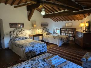 a bedroom with three beds and a book shelf at Castello Di Potentino in Seggiano +66 photos