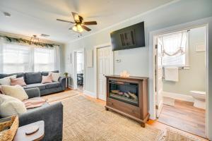 a living room with a couch and a fireplace at Family-Friendly Main St Gloucester Apt with Balcony! in Gloucester