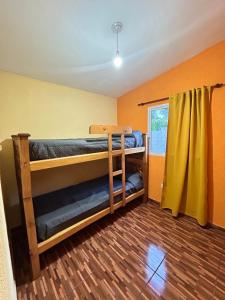 a room with two bunk beds and a window at La casita de Oli in Tanti