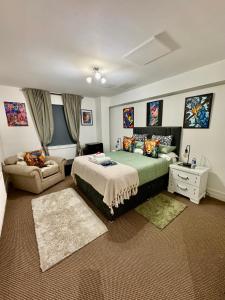 a bedroom with a large bed and a couch at LoughView BED & BREAKFAST in Belfast +43 photos