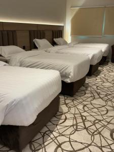 Postel nebo postele na pokoji v ubytování Dvina Hotel دفينا