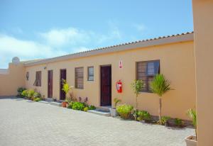 a building with palm trees in front of it at Josef Self Catering in Swakopmund