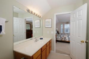 a bathroom with a sink and a mirror at Conveniently located in Pigeon Forge, spacious & clean 3 bedroom! in Pigeon Forge +25 photos