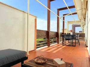 een kamer met een balkon met een tafel en stoelen bij Appartamento Spiga in San Vincenzo