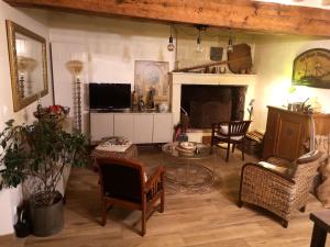 a living room filled with furniture and a fireplace at la Ferme du Grand Bois in Mouterre-Silly
