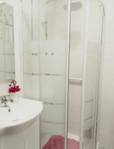 a white bathroom with a shower and a sink at Traditional House in Pera in Pera +12 photos