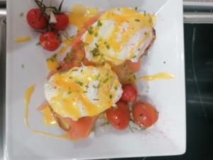 a white plate with eggs on top of tomatoes at No 12 B&B in Dungarvan
