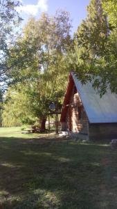 einem Blockhaus in der Mitte eines Feldes in der Unterkunft Cabaña Alpina in Rodeo + 2 Fotos