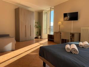 a hotel room with a bed with towels on it at Casa al Lago in Lecco