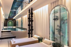 a lobby with a large painting of a woman at Hotel Le Negresco in Nice