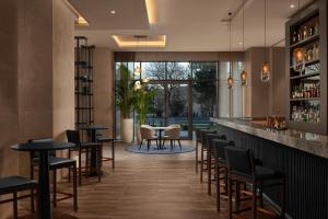 a bar with chairs and tables in a restaurant at Cappadocia Marriott Hotel in Nevsehir