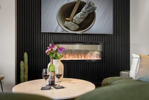 a living room with a table with wine glasses and a fire place at Sage Villa in Sedona
