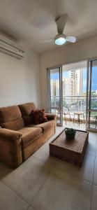 a living room with a couch and a table at Condominium SPAZIO BLU in Sao Jose do Rio Preto