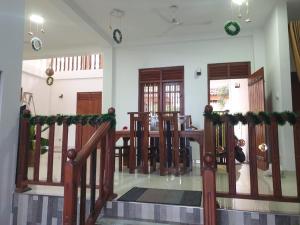 a living room with a dining room table and stairs at Lanka villa mirissa private villa 6bedrooms in Mirissa +115 photos