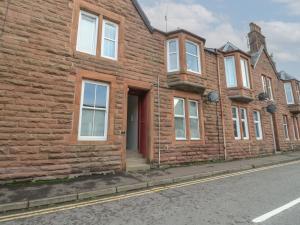 a row of brick houses on the side of a street at Lismore in Crieff
