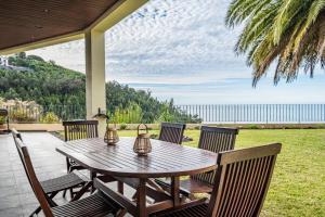 a wooden table and chairs on a patio at Palmeira`s Village in São Gonçalo