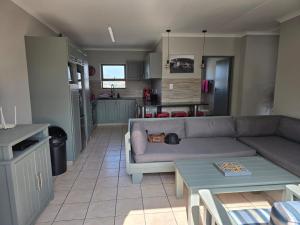 a living room with a couch and a table at Sedgefield in Sedgefield
