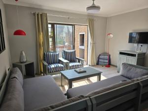 a living room with a couch and chairs and a table at Sedgefield in Sedgefield
