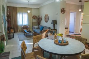 a living room with a table and a couch at Marvic House in Exaplátanos