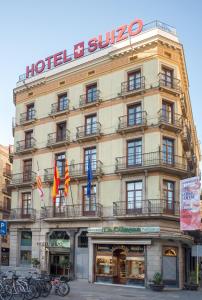 a large building with a clock on the front of it at Hotel Suizo in Barcelona