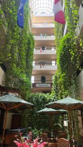 a patio with umbrellas and chairs and a building at Hotel Boulevard in Lima