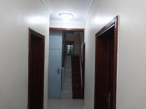 a hallway with two open doors and a stairway at MARACANA Taverna Ltd in Kigali