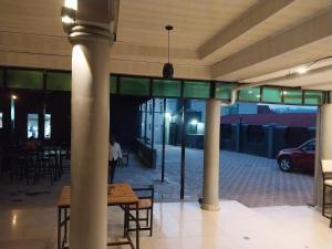 a room with columns and a table in a building at MARACANA Taverna Ltd in Kigali