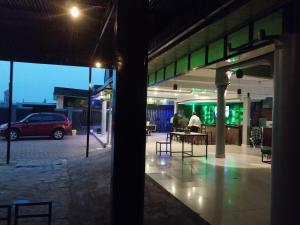 a person sitting at a table in a parking lot at MARACANA Taverna Ltd in Kigali