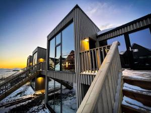 a house with large glass windows on a beach at Modern One-Bedroom Apartment in Henningsvær in Henningsvær
