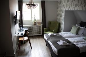 Ένα ή περισσότερα κρεβάτια σε δωμάτιο στο Hotell Esplanad