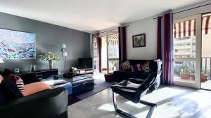 a living room with a couch and a chair at Casamea - Spacieux T3 famille, Vue mer, Parking in Ajaccio