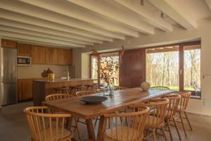 a kitchen with a large wooden table and chairs at Cabaña Quieva 04 in Rubalcaba
