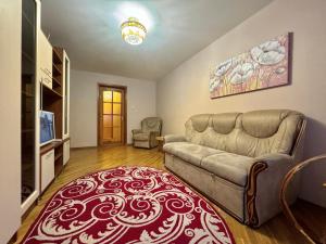 un soggiorno con un divano e una televisione di ApartPoltava Затишна 3-кімнатна квартира в центрі міста, КАШТАНОВА АЛЕЯ, звітна документація, ЧЕК a Poltava