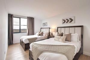 a hotel room with two beds and a window at Unique stunning ski in-out condo in Tremblant in Mont-Tremblant
