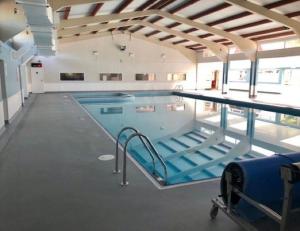 a large indoor swimming pool with two lanes at Chalet 67 in Kingsdown