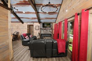 a living room with leather furniture and red curtains at Newly renovated 2 BR in convenient location! in Sevierville